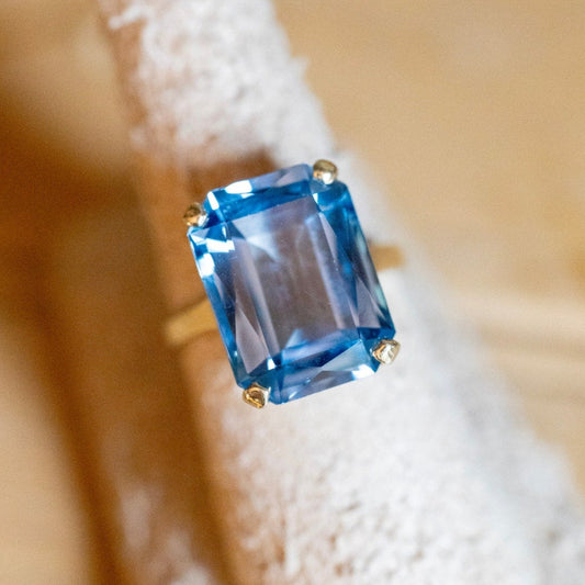 A Dramatic 14K Yellow Gold Ring Featuring a Rectangle Cut Blue Topaz
