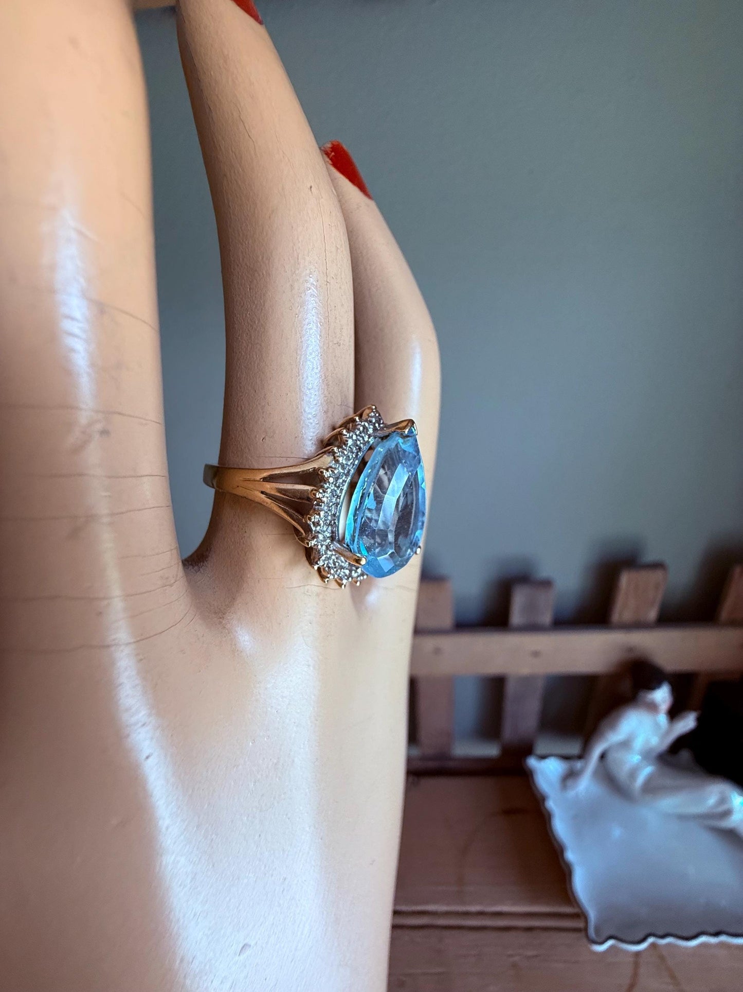 A Large Pear Shaped Blue Topaz Diamond Halo Ring in 10K Yellow and White Gold