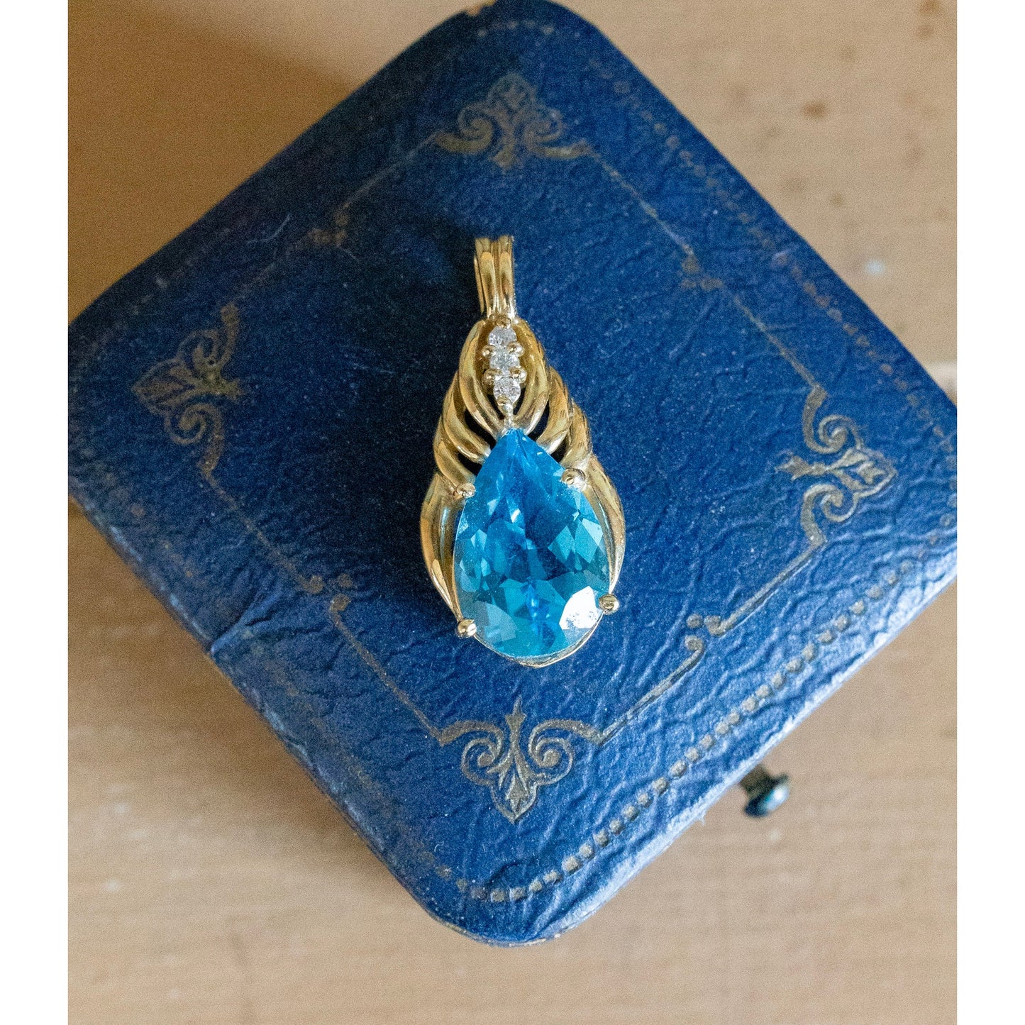 A Brilliant Blue Topaz and Diamond 10K Yellow Gold Pendant