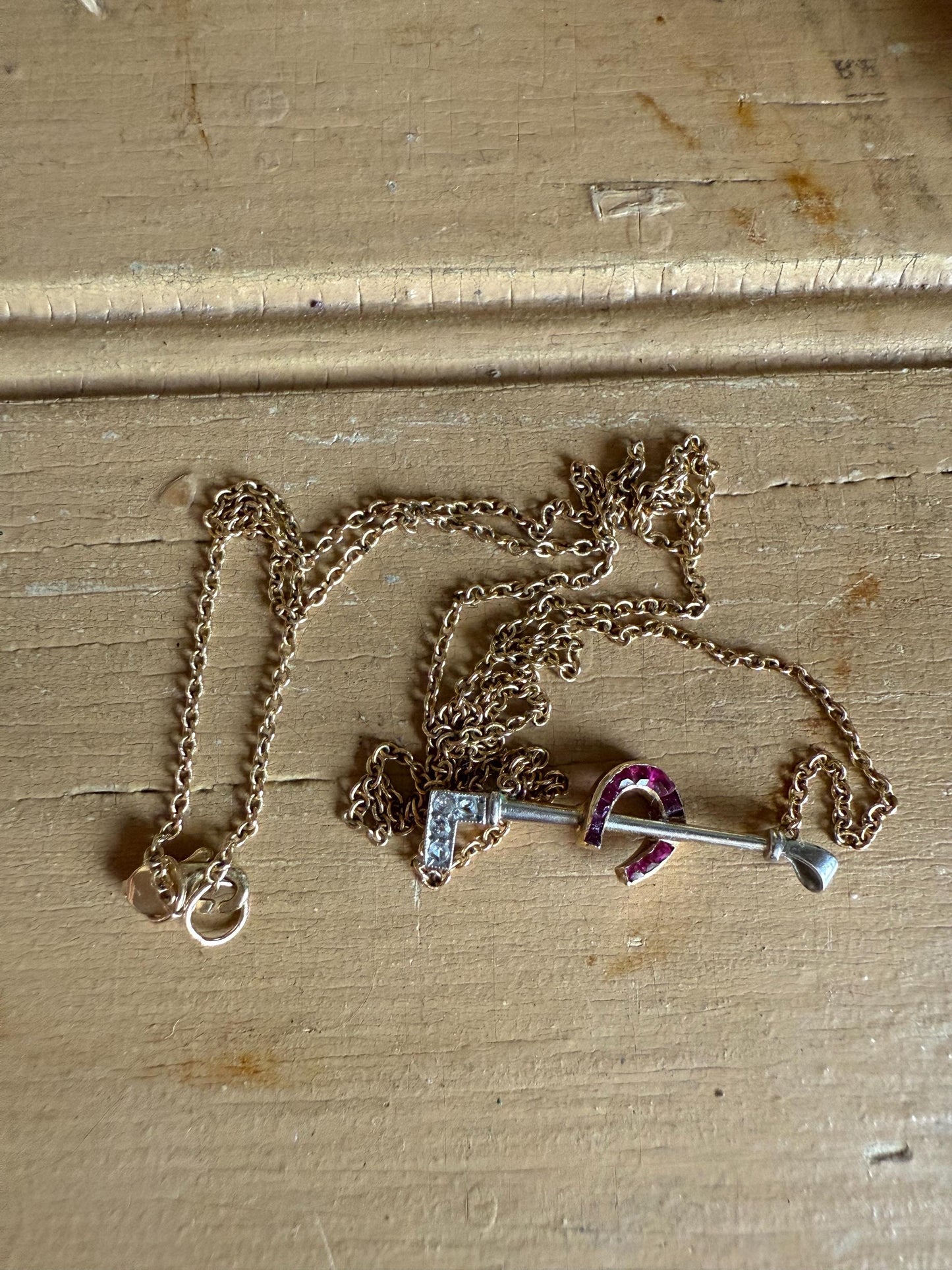 c1930 14K Yellow and White Gold Horse Crop and Lucky Ruby Set Horseshoe Necklace