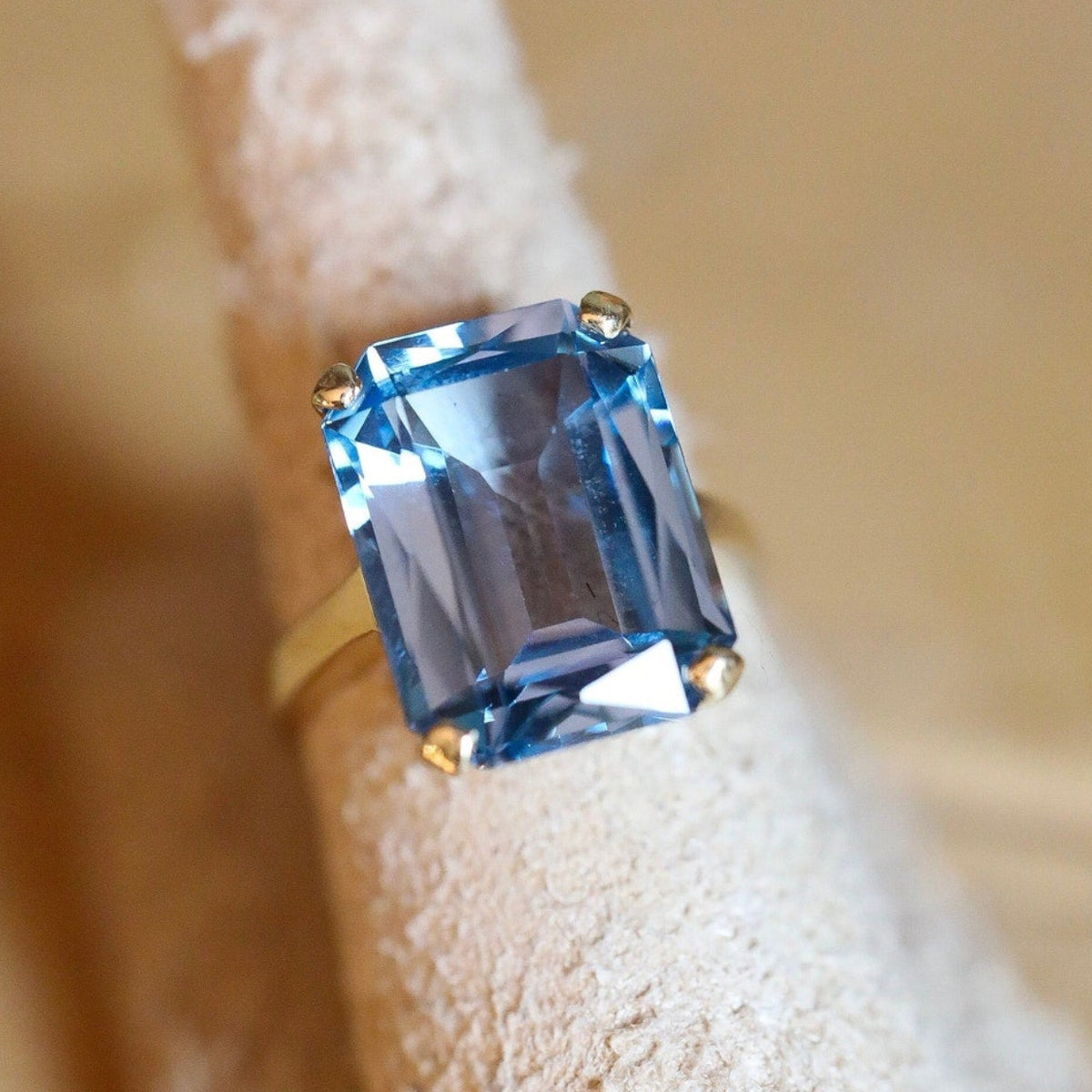 A Dramatic 14K Yellow Gold Ring Featuring a Rectangle Cut Blue Topaz