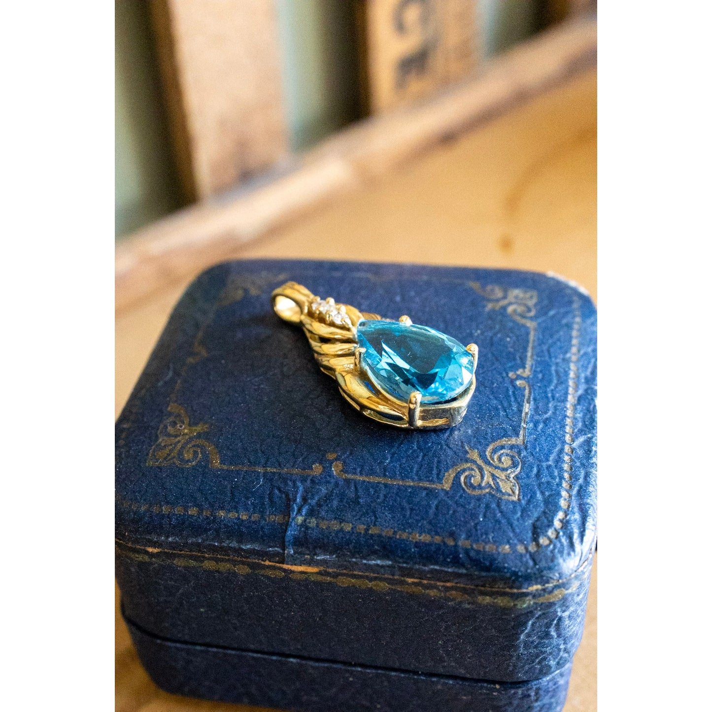 A Brilliant Blue Topaz and Diamond 10K Yellow Gold Pendant