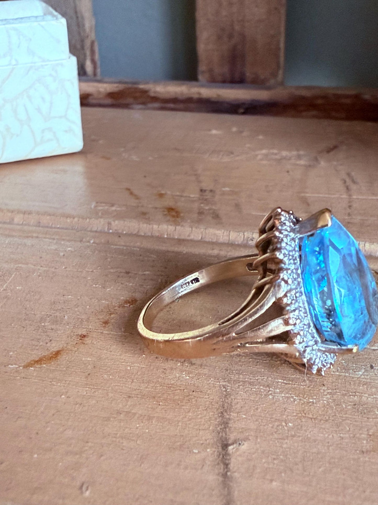 A Large Pear Shaped Blue Topaz Diamond Halo Ring in 10K Yellow and White Gold