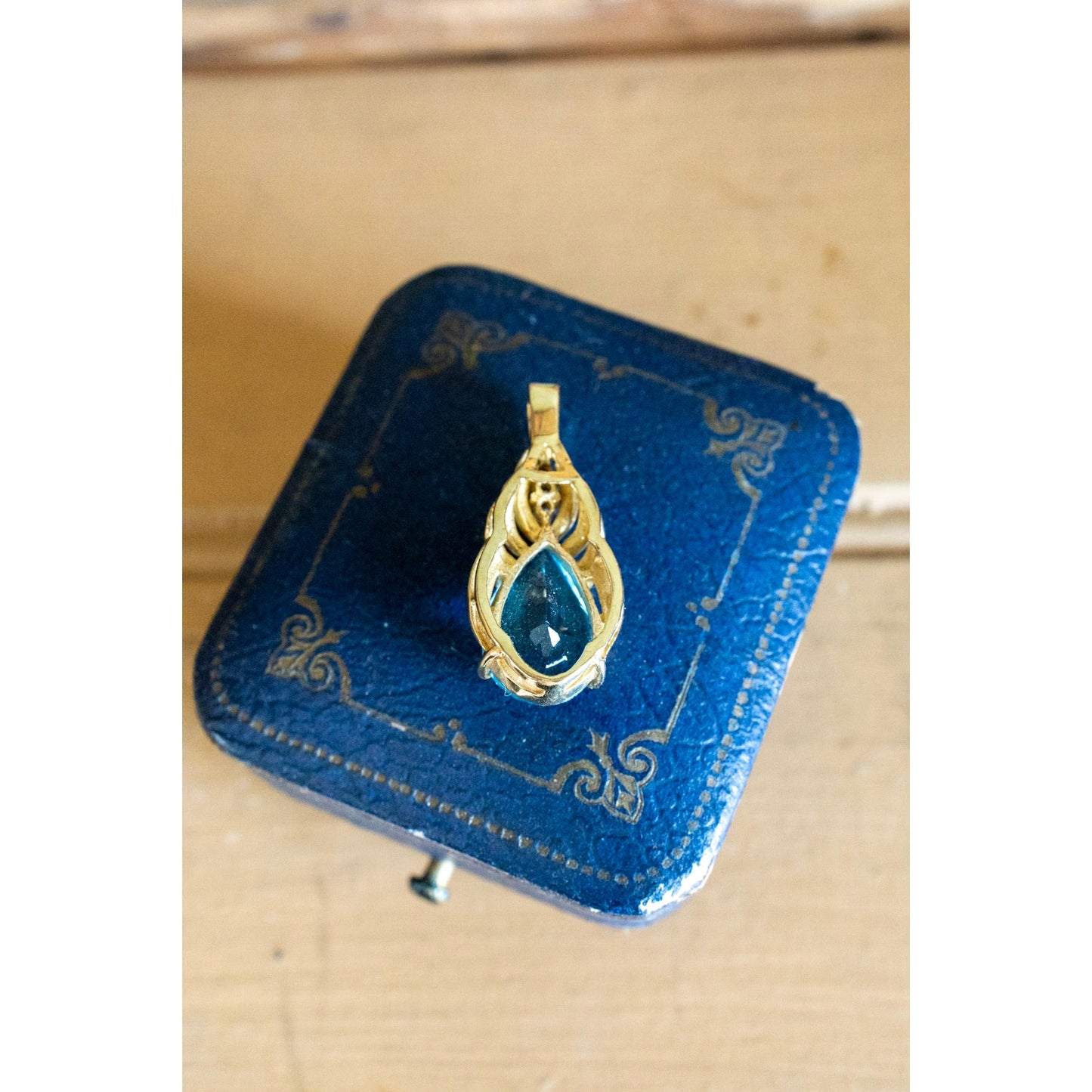 A Brilliant Blue Topaz and Diamond 10K Yellow Gold Pendant