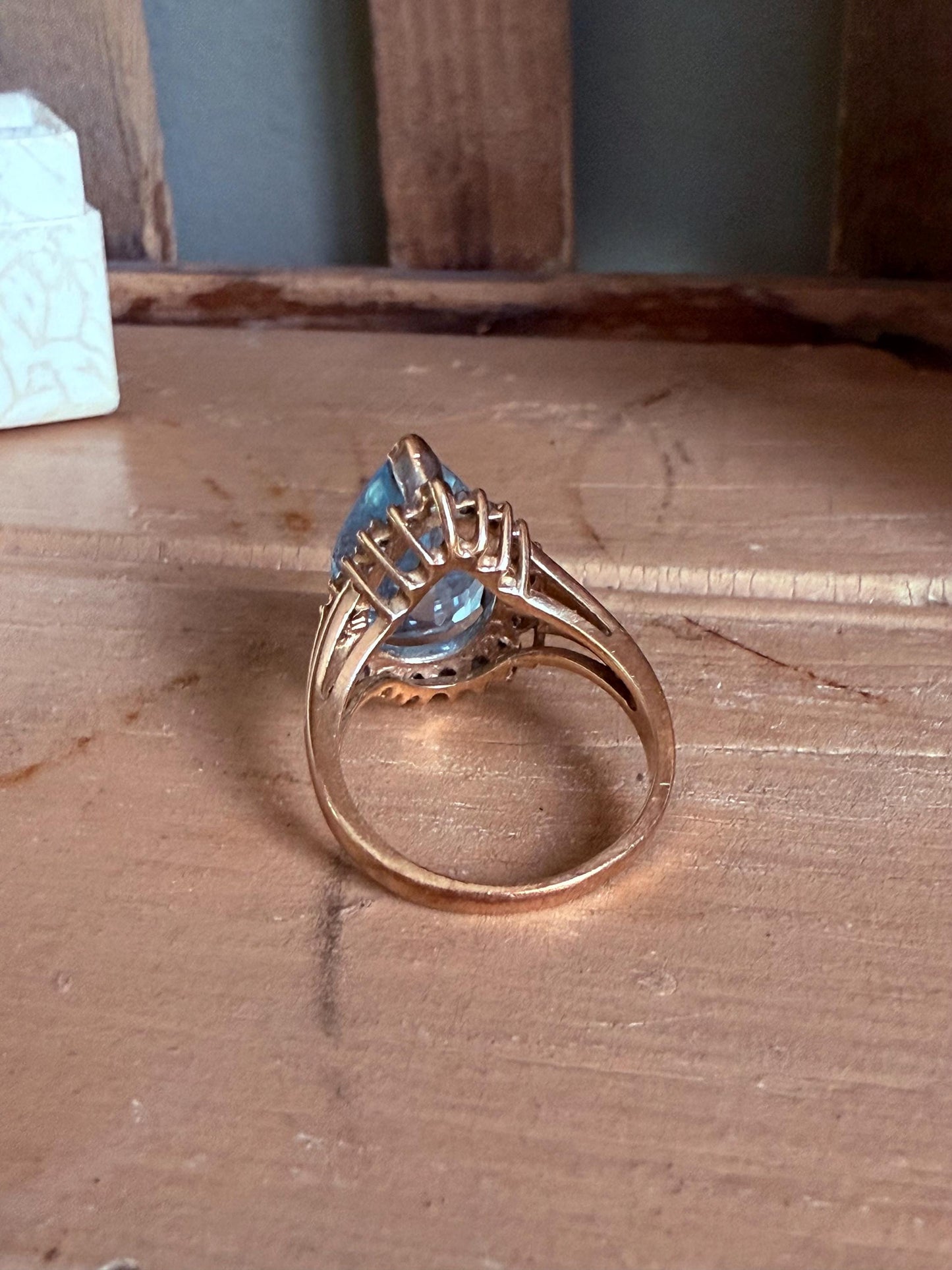 A Large Pear Shaped Blue Topaz Diamond Halo Ring in 10K Yellow and White Gold