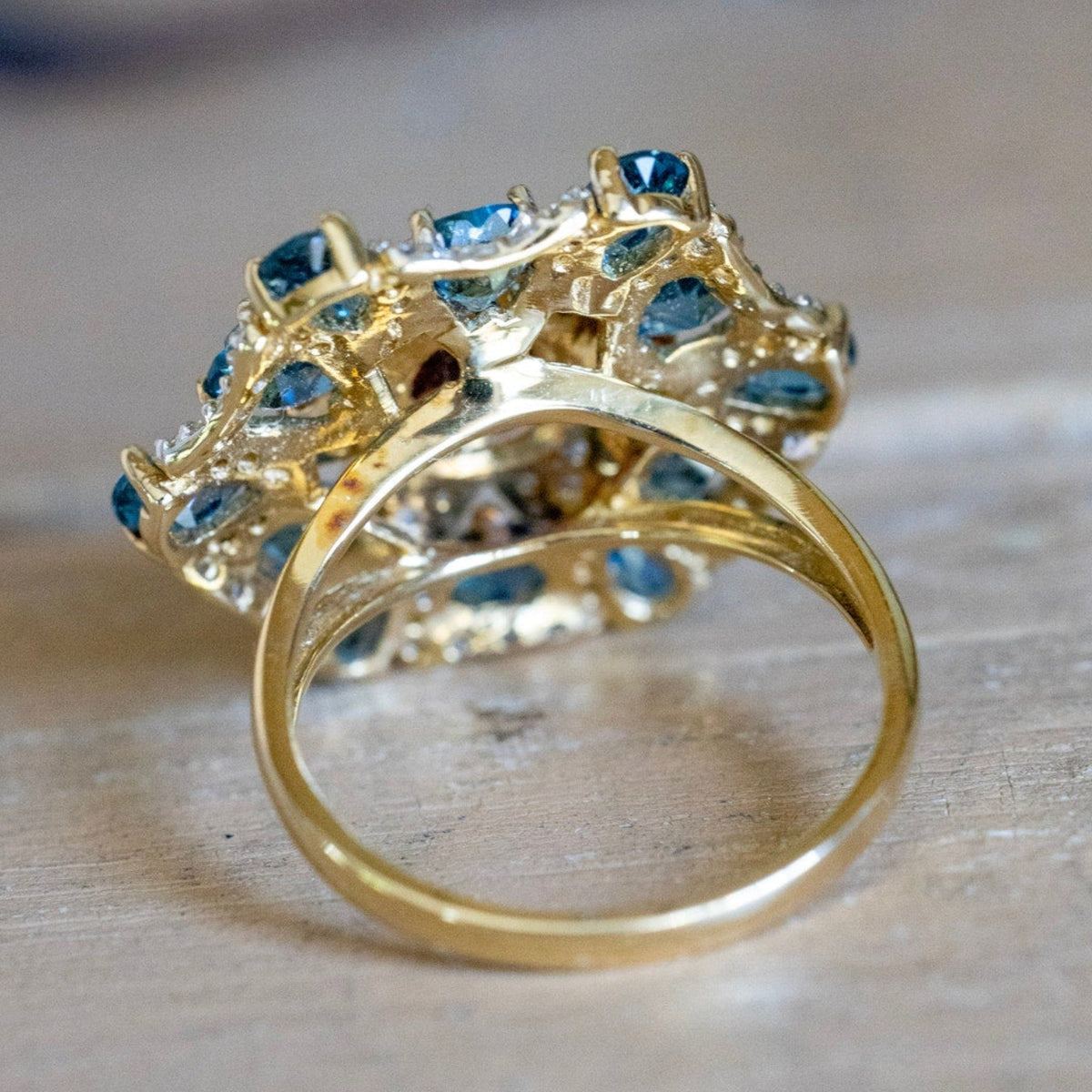 A 14K Yellow Gold Large Flower Snowflake Ring Featuring Garnet, Blue Topaz and Diamonds