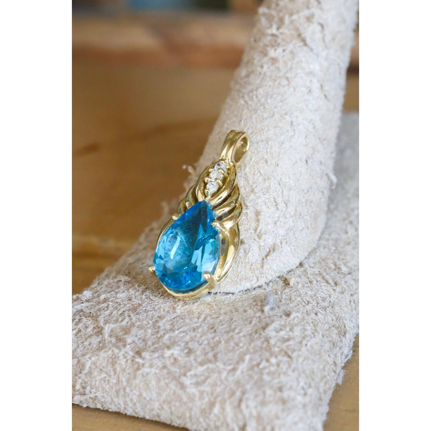 A Brilliant Blue Topaz and Diamond 10K Yellow Gold Pendant