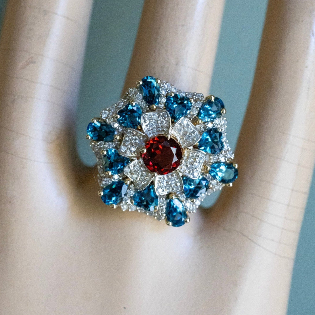 A 14K Yellow Gold Large Flower Snowflake Ring Featuring Garnet, Blue Topaz and Diamonds