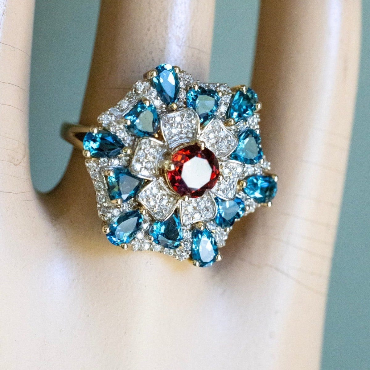 A 14K Yellow Gold Large Flower Snowflake Ring Featuring Garnet, Blue Topaz and Diamonds
