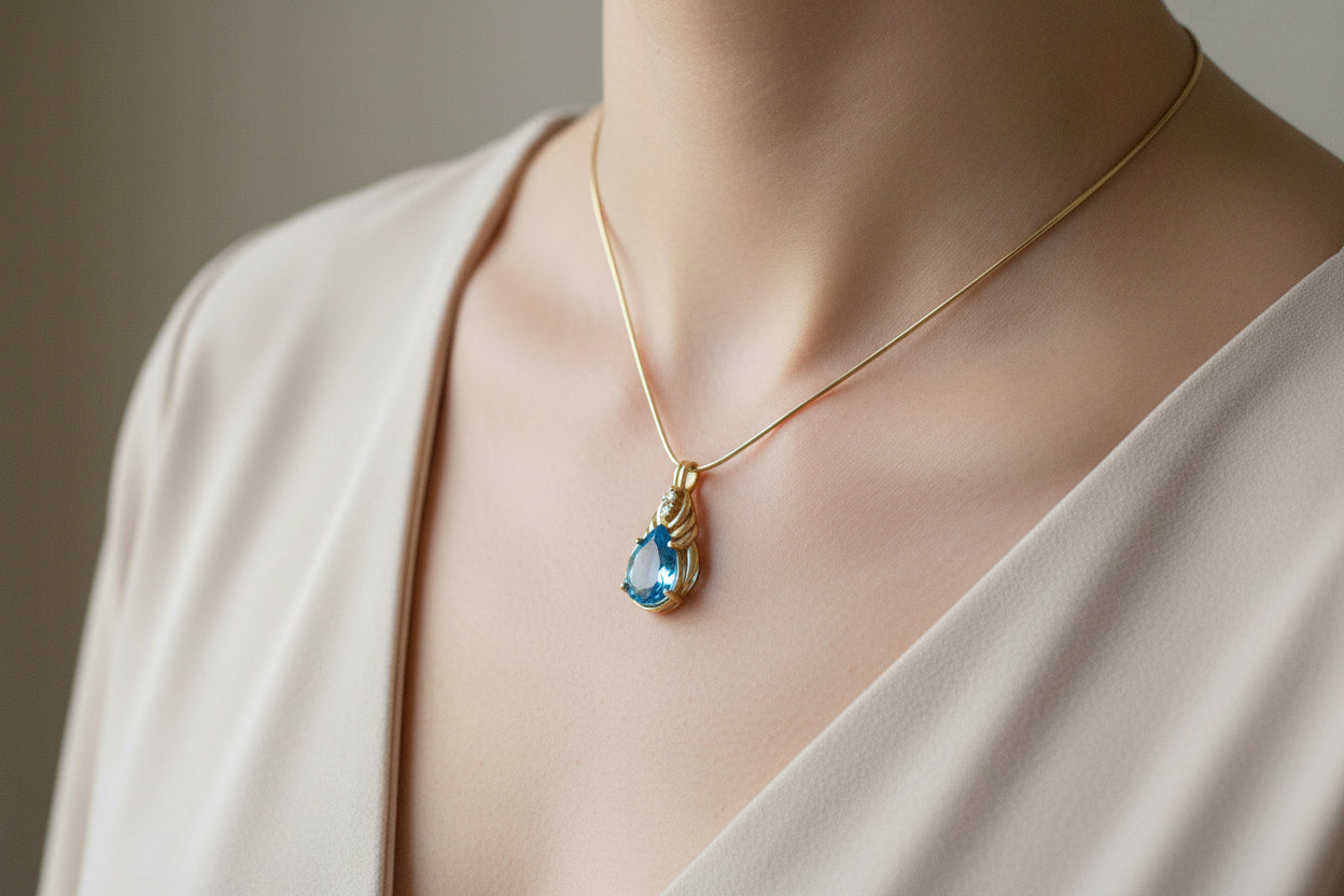 A Brilliant Blue Topaz and Diamond 10K Yellow Gold Pendant