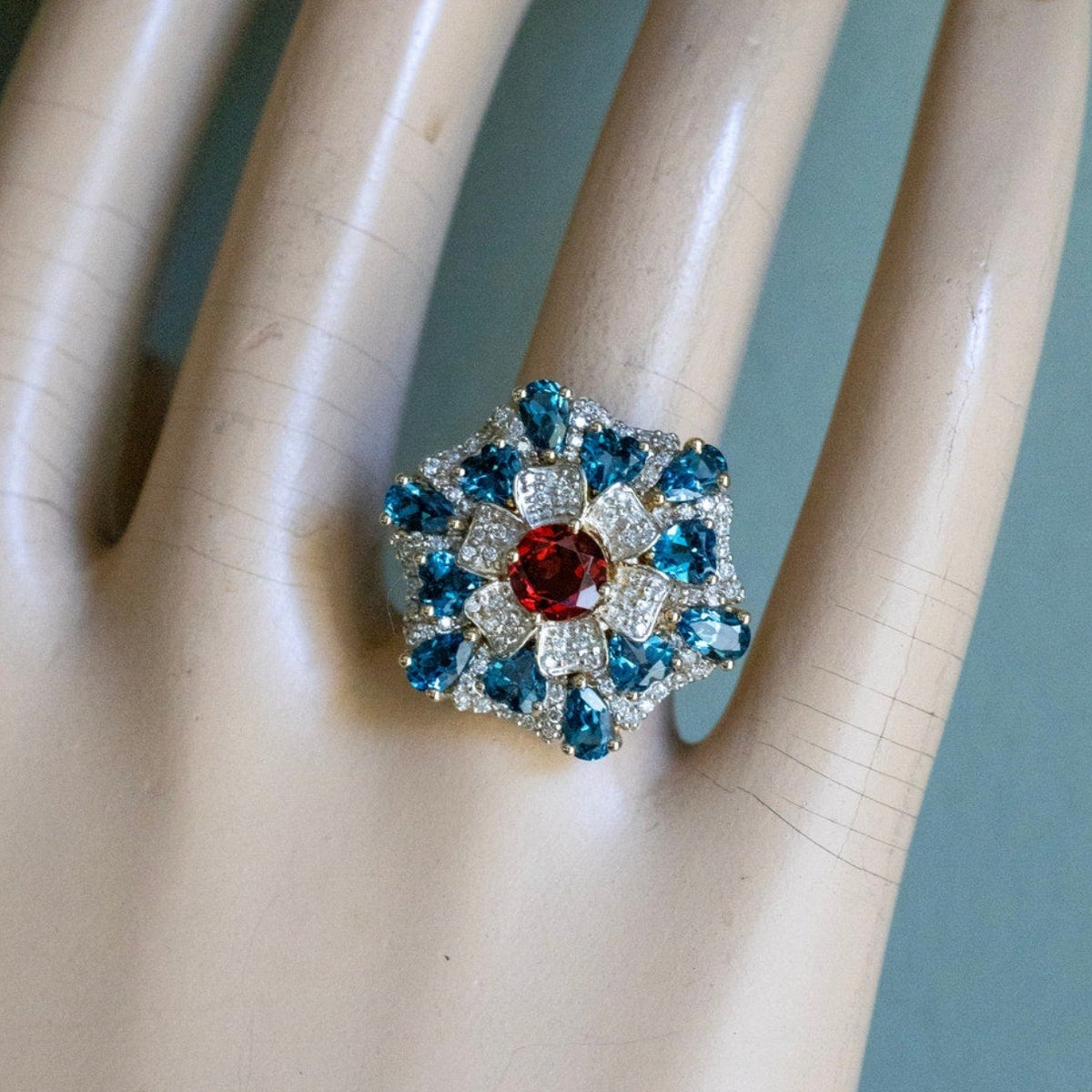 A 14K Yellow Gold Large Flower Snowflake Ring Featuring Garnet, Blue Topaz and Diamonds