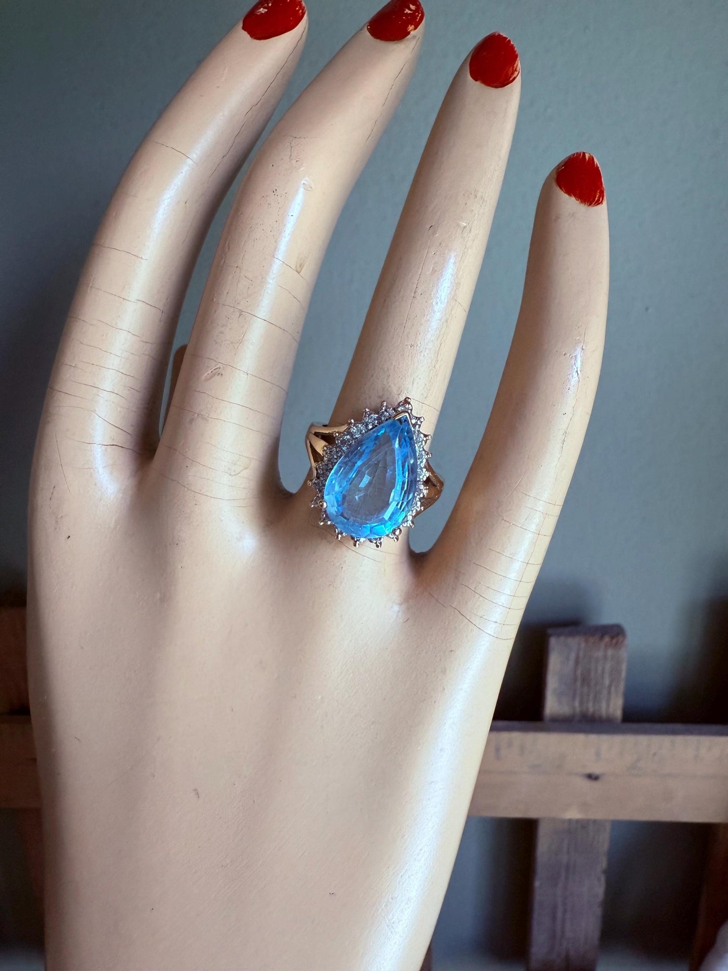 A Large Pear Shaped Blue Topaz Diamond Halo Ring in 10K Yellow and White Gold