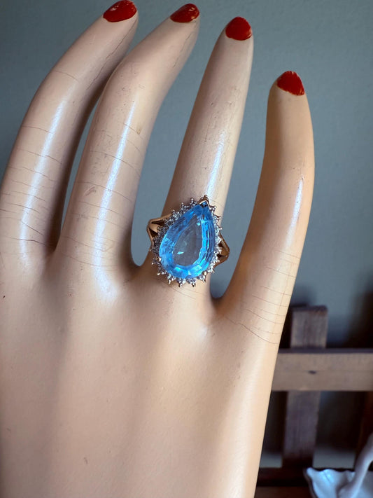 A Large Pear Shaped Blue Topaz Diamond Halo Ring in 10K Yellow and White Gold