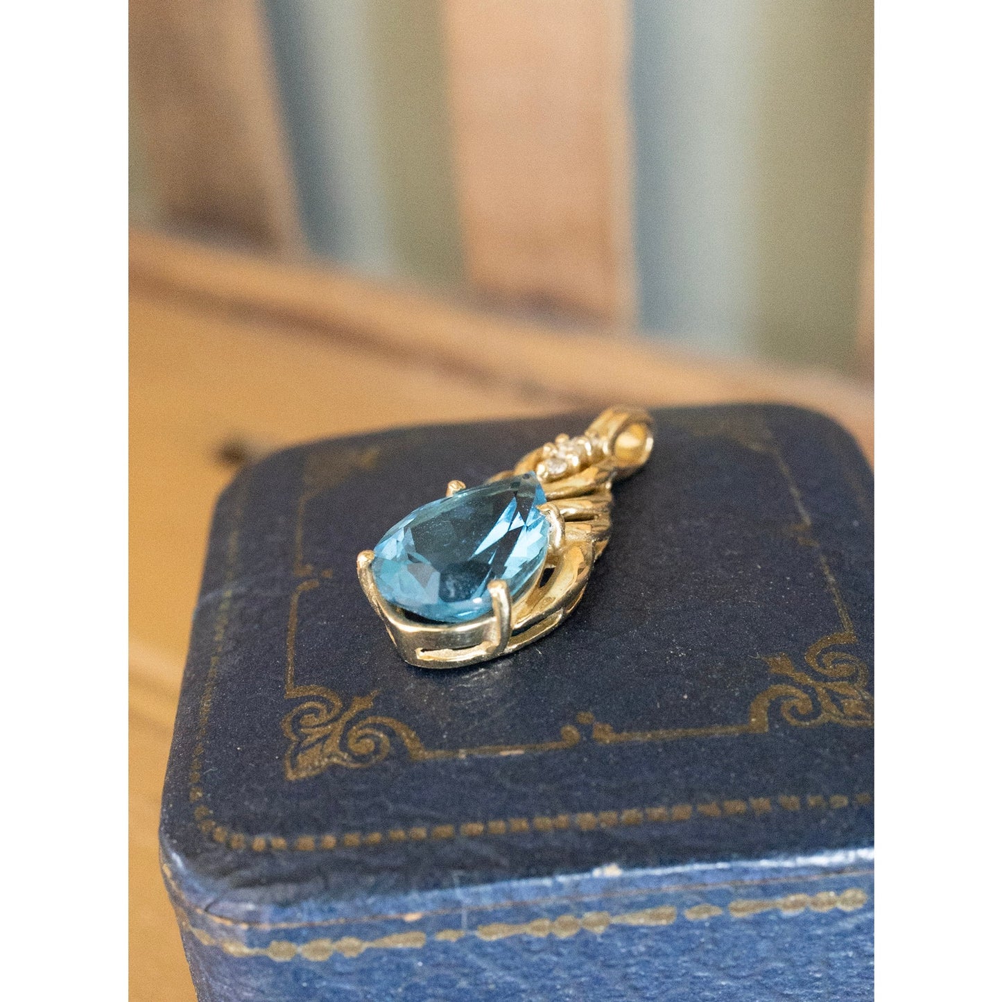 A Brilliant Blue Topaz and Diamond 10K Yellow Gold Pendant