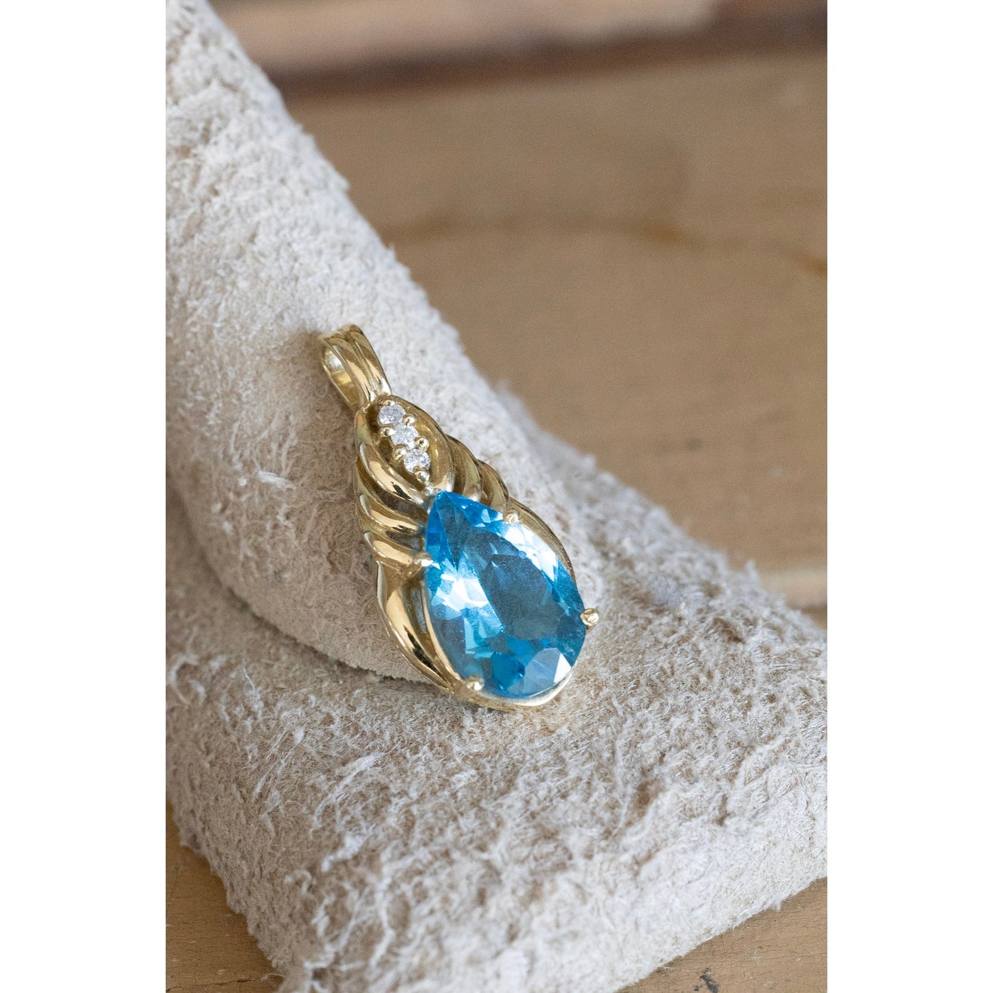A Brilliant Blue Topaz and Diamond 10K Yellow Gold Pendant
