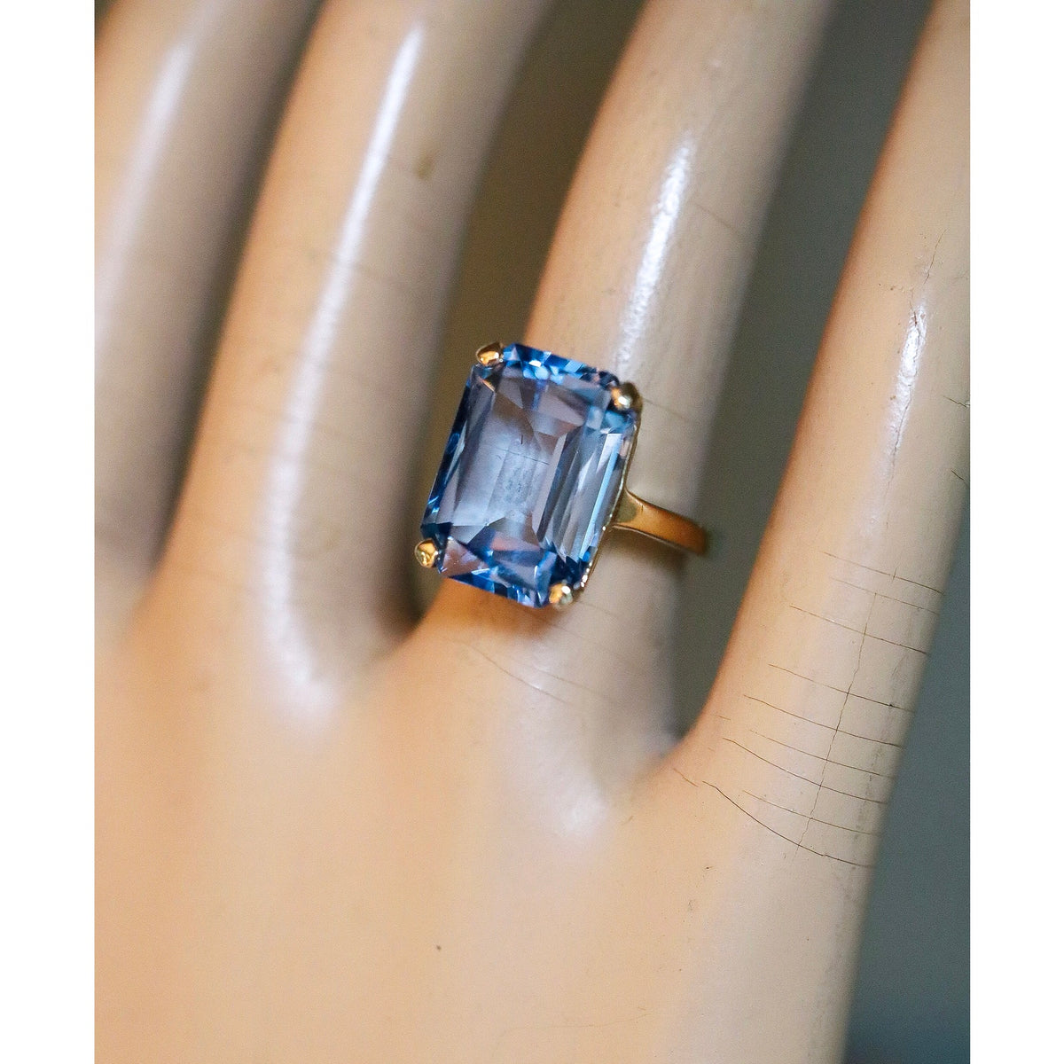A Dramatic 14K Yellow Gold Ring Featuring a Rectangle Cut Blue Topaz