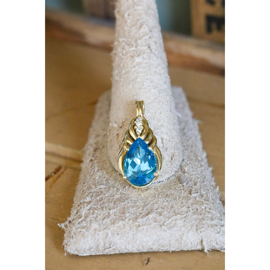 A Brilliant Blue Topaz and Diamond 10K Yellow Gold Pendant